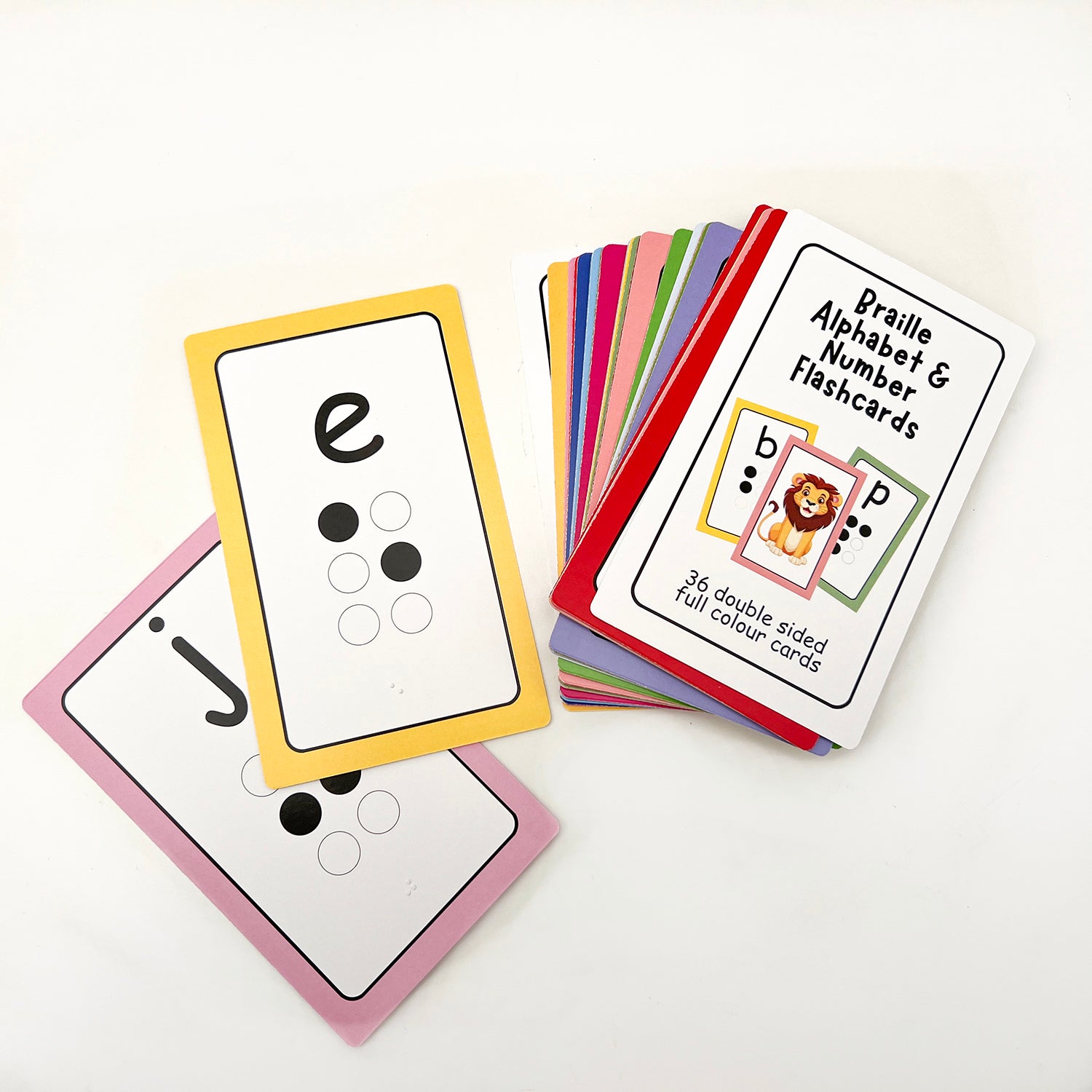 A set of colourful braille alphabet and number flashcards, featuring large printed letters and tactile braille dots on one side, and bright images on the other.