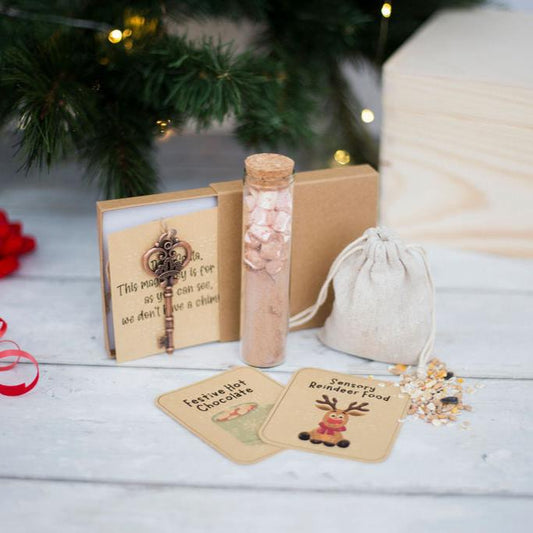 A bundle containing sensory reindeer food, festive hot chocolate and a santa key. All have braille on the labels. 