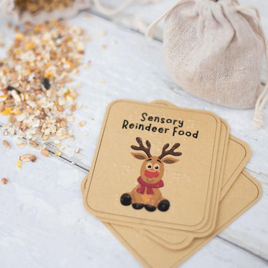 A label saying sensory reindeer food in print and braille, with the image of a reindeer on the label. In the background is reindeer food and a hessian bag.