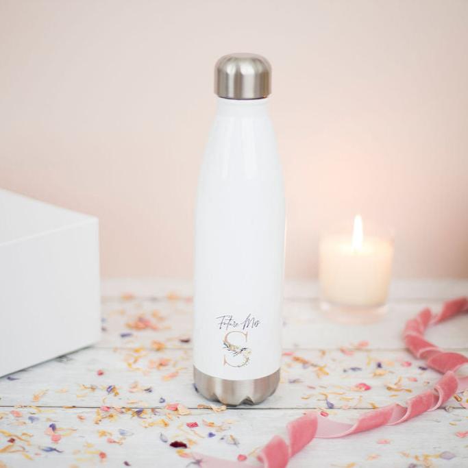 A glossy white water bottle with Future Mrs S in print with a candle in the background and pink ribbon to the side.